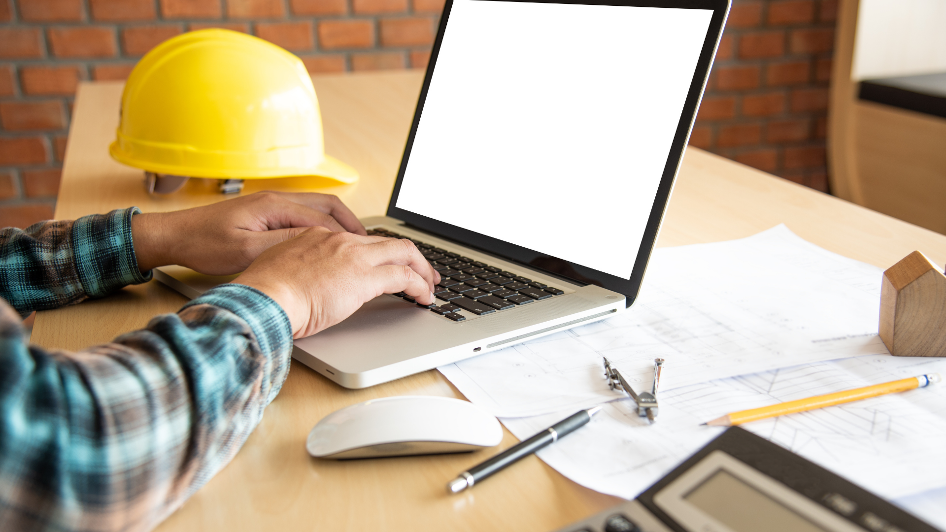 construction employee on a laptop 