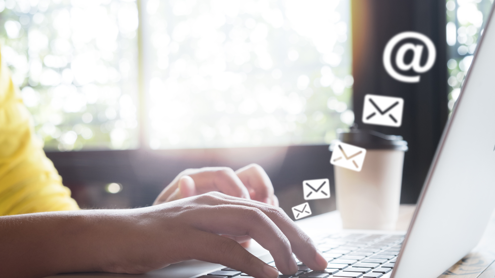 Man sending emails from his laptop