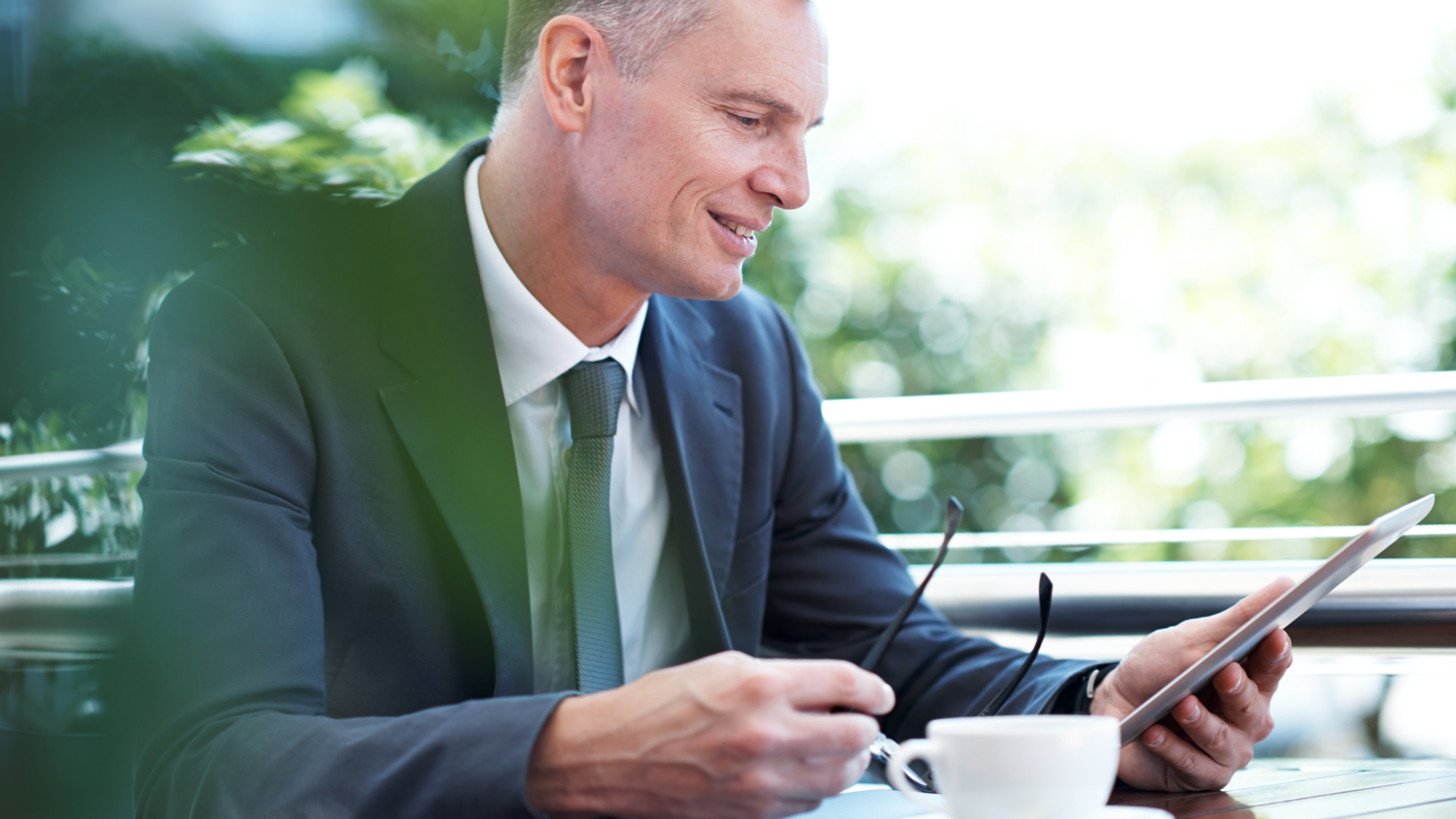 Man working from a tablet while sitting outside