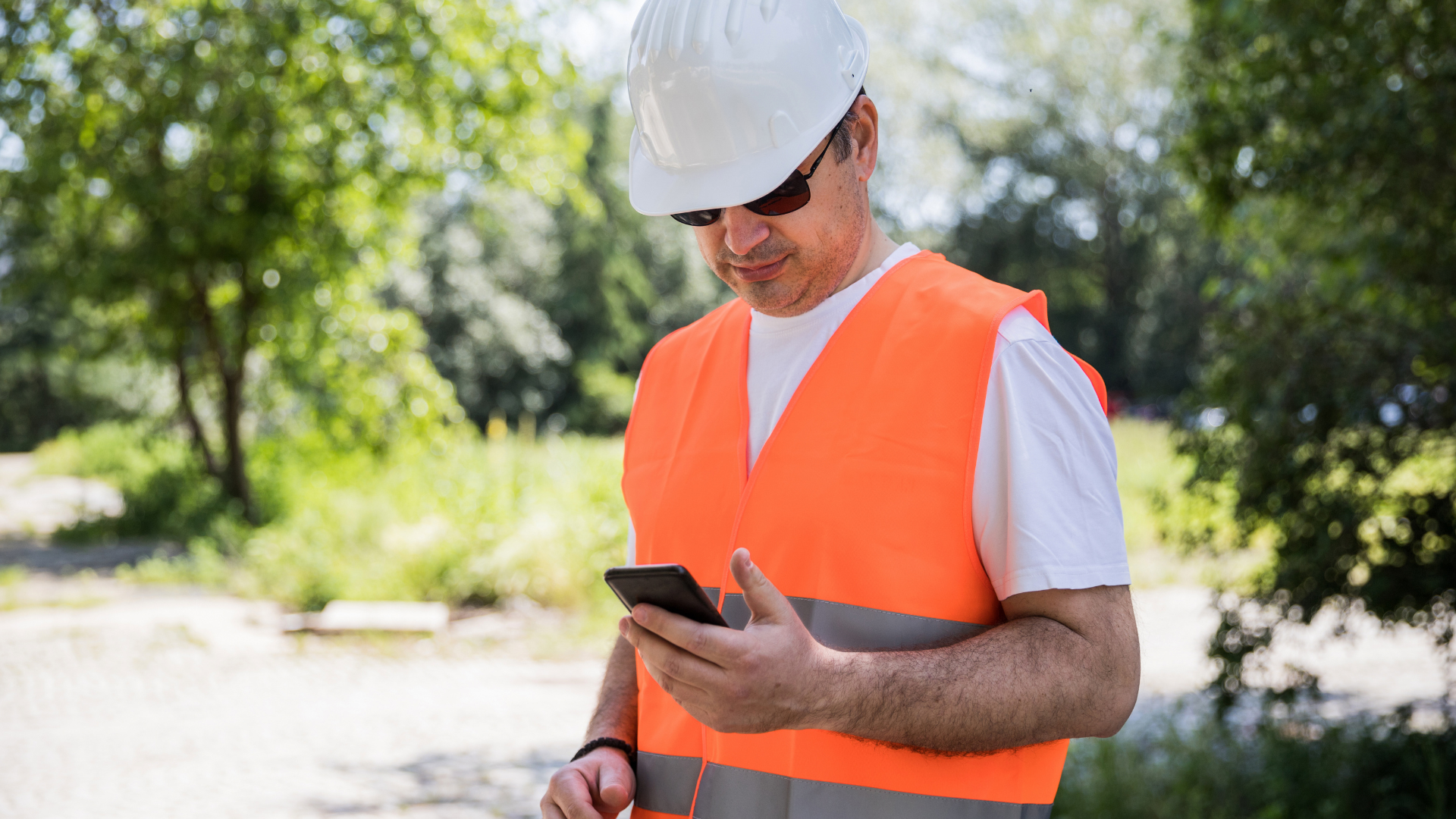 Construction worker on site working from a mobile device