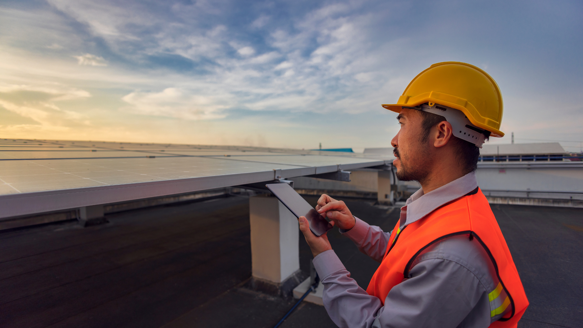 Construction worker on a roof working from a mobile device