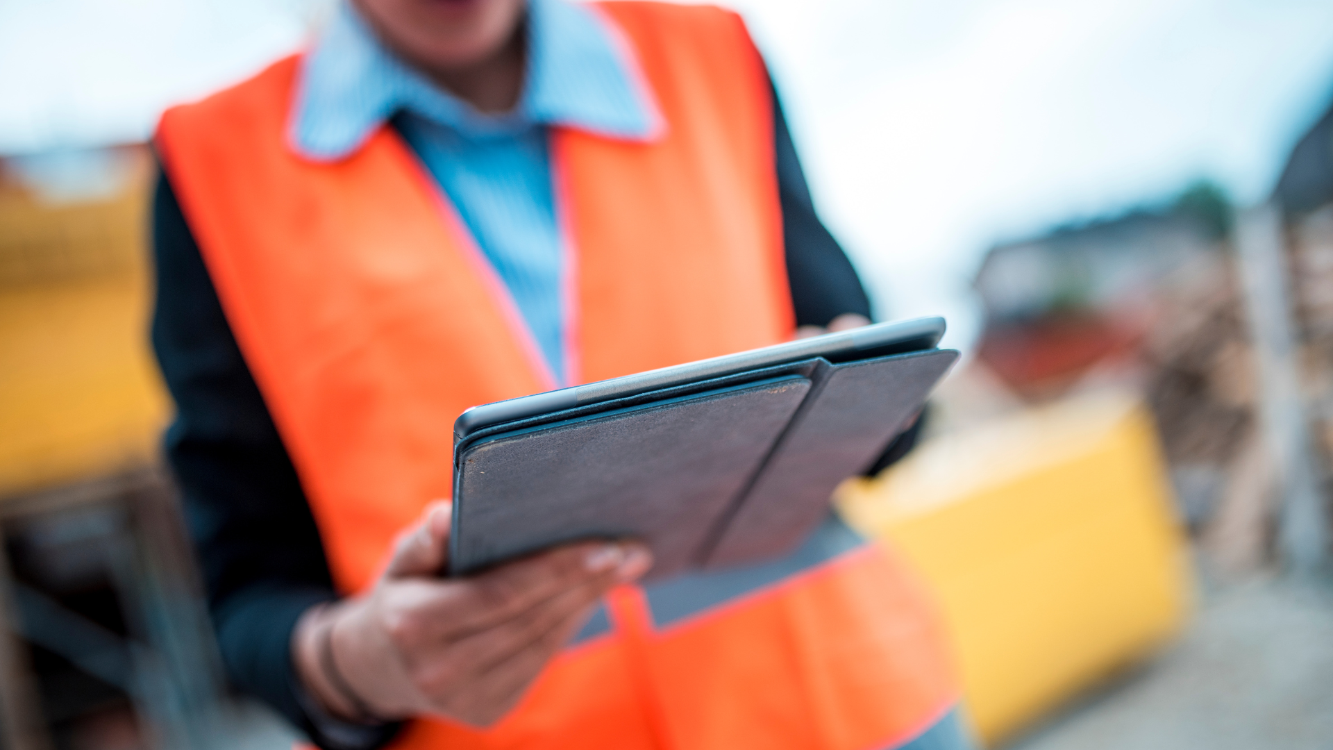 Construction worker on site working from a tablet