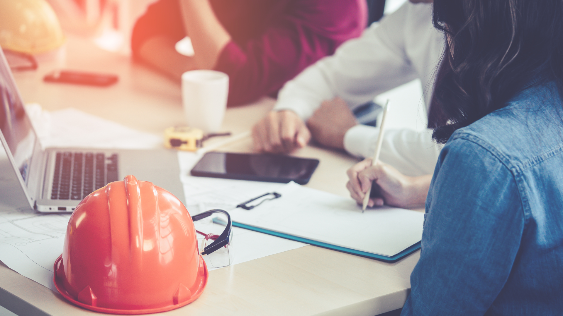 Colleagues in a construction office working from a laptopo 